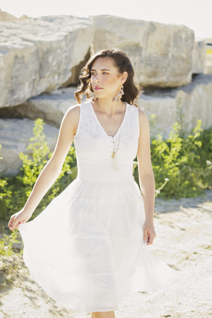 profile of model in white dress walking