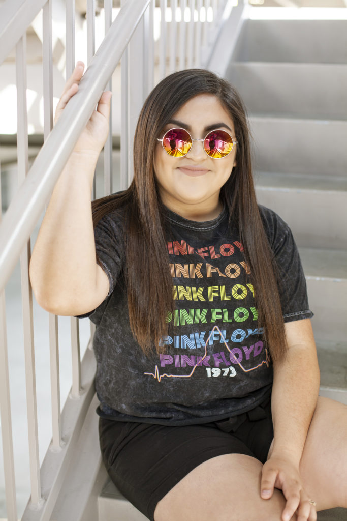 girl in sunglasses sitting on stairs