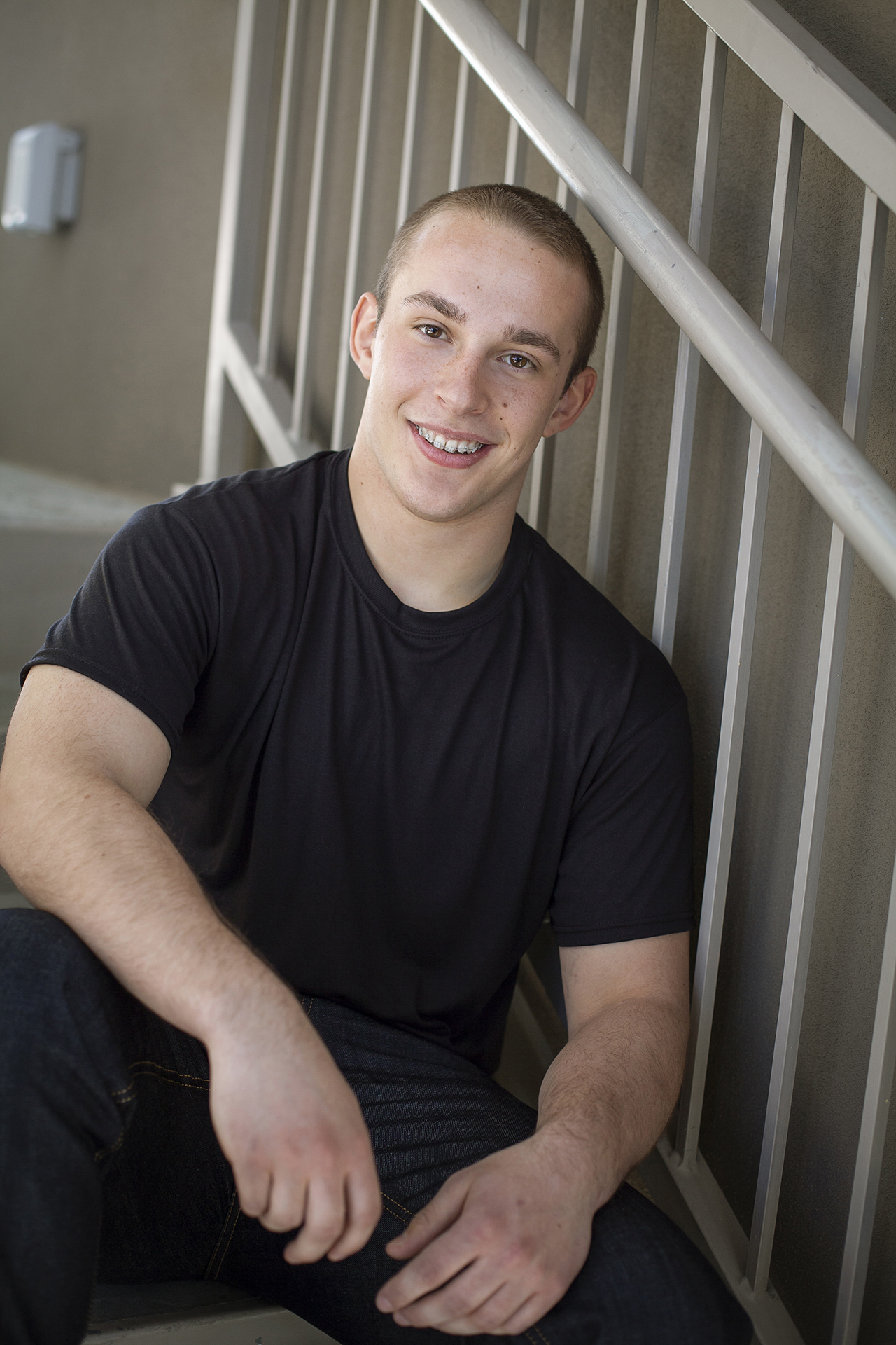 senior photography of guy sitting on stairs